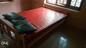 Red Mattress With Brown Wooden Flatbed