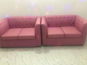 Two Tufted Pink Leather Padded Loveseats