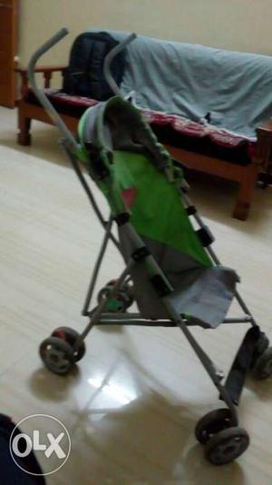 Baby's Grey And Green Lightweight Stroller foldable.