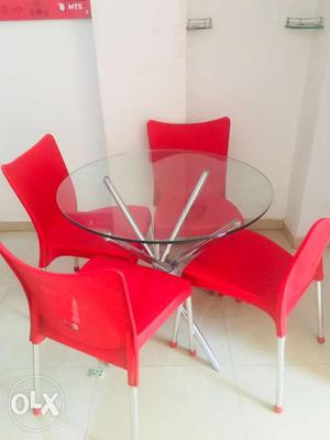 Stunning round table with four Vibrant red chairs
