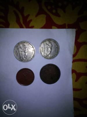 Two Round Silver-colored And Two Round Copper Coins