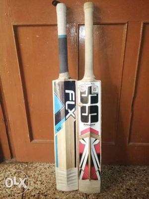 Two White-and-blue And White-and-red Cricket Bats