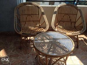 Two Brown Rattan Chairs And Table