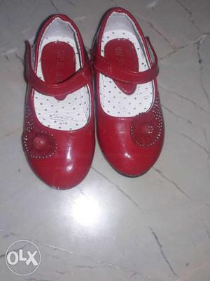Girl's Pair Of Red Shoes