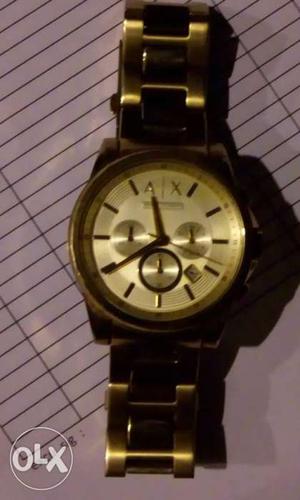 It is ARMANI EXCHANGE watch in gold colour. Its
