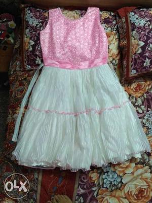 It is nice white and pink party wear frock.