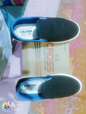 Pair Of Black And Blue Cross Slip On Shoes