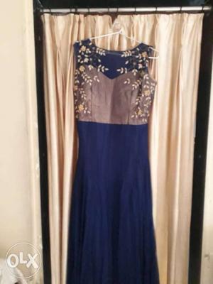 Royal blue gown with beautiful stone on front side.