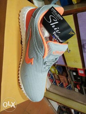 Unpaired Gray, Orange, And White Shiu Shoe