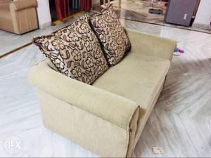 Beige Loveseat With Brown Floral Throw Pillows