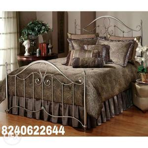 Brown Bedding Set On Stainless Steel Bed Frame