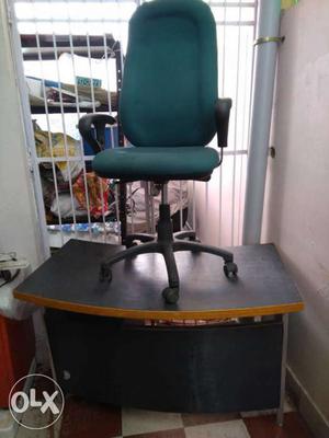 Green Fabric Rolling Chair And Black Wooden Desk