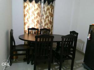 Oval Black Wooden Dining Set with six chairs