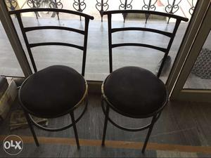 Two Black Metal Framed Black Padded Chairs