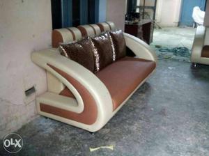 White And Brown Leather Sofa With Three Throw Pillows