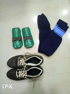 Pair Of Blue Socks; White-black Sneakers; Pair Of Green Shin