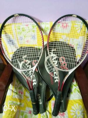Two Black And Red Tennis Rackets With Bags