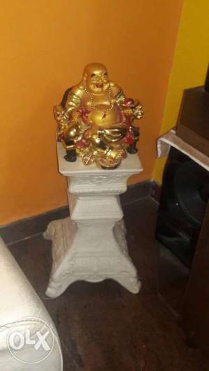 A marble pillar stand and a buddha statue