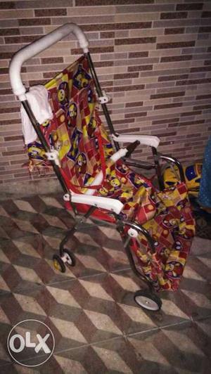 Baby's Red And Yellow Stroller
