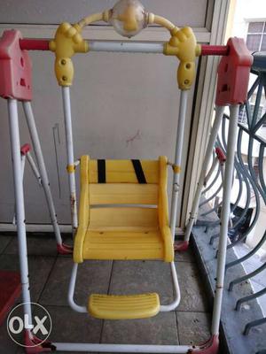 Baby's Red, White, And Yellow Swing Chair