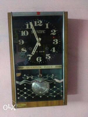 Brown Wall-mounted Pendulum Clock