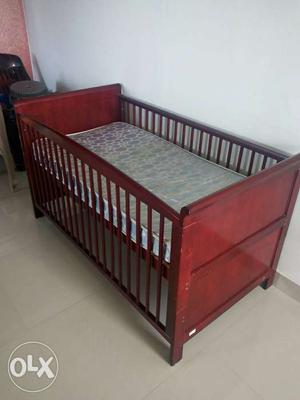 Brown Wooden Crib With Mattress