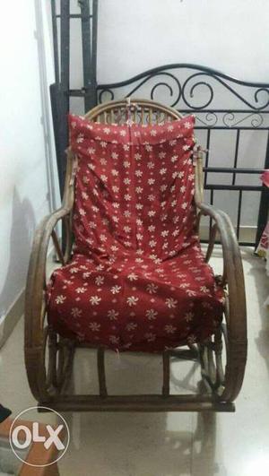 Cane rocking chair with seating mattress.