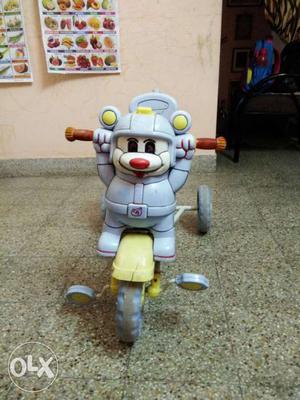 Children tricycle with hood and pushing handle