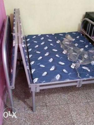 Gray Steel Folding Bed Frame With Blue Mattress