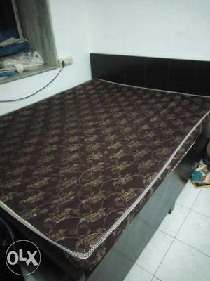 Queen size bed with mattress and storage.