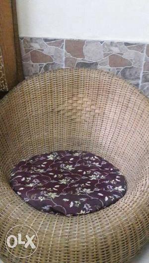 Round lounge chair made up of cane