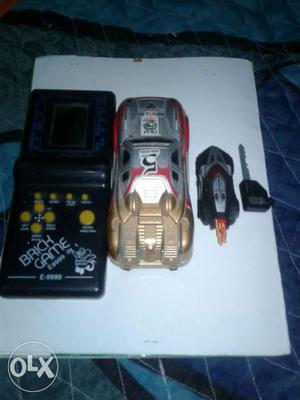 Two Car Toys, Keys, And Brick Game Handheld Game Console