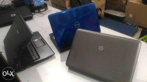 Three Blue, Gray, And Black Laptop Computers