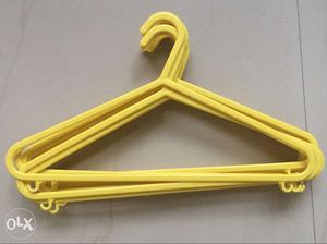 12 Yellow Plastic Clothes Hangers