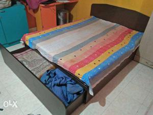 Black Wooden Bed Frame With Mattress, Blanket, And Bed Sheet
