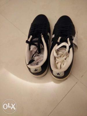 Pair Of Black, And White Low Top Sneakers