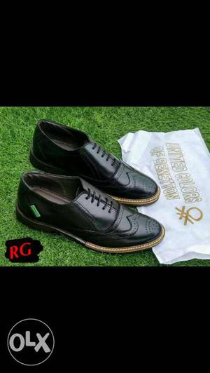 Pair Of Black Leather Wingtip Shoes