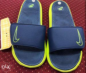 Pair Of Black-and-yellow Nike Slide Sandals