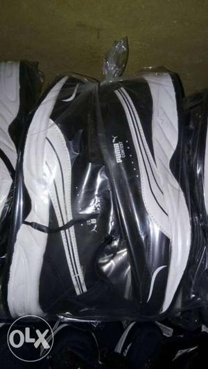 Pair Of White-and-black Puma Athletic Shoes