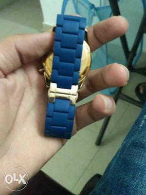 Round Gold-colored Watch With Blue Strap