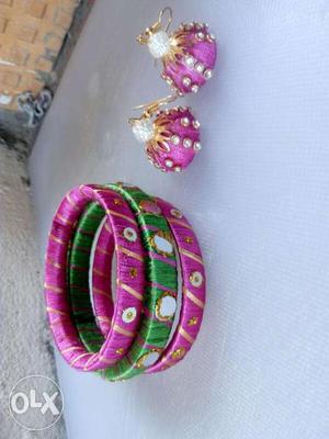 Two Purple And One Green Silk Tread Bangles And Two Pink