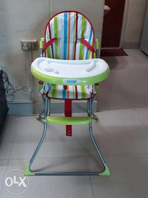 Baby's Red, Green, And White Feeding Chair