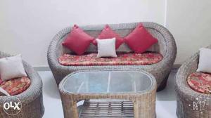 Brown Wicker Basket With Red And White Throw Pillows