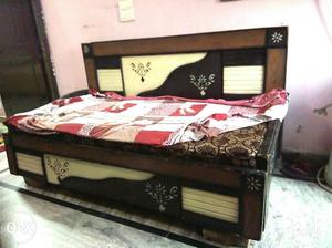 Brown Wooden Day Bed With Red Bedding Sheet
