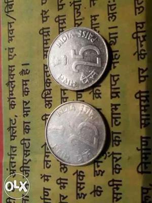Two Round Silver-colored 25 Indian Paise Coins