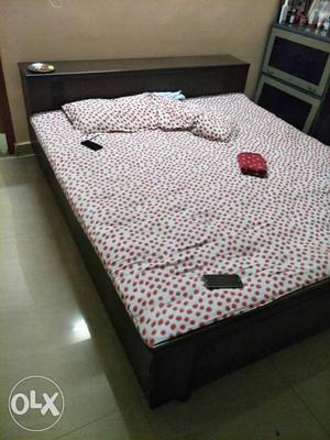 Full Size Brown Wooden Bed With White And Red Floral Bed Set