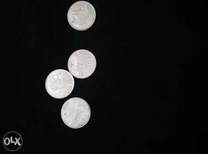 Four Several Round Silver-colored Coins