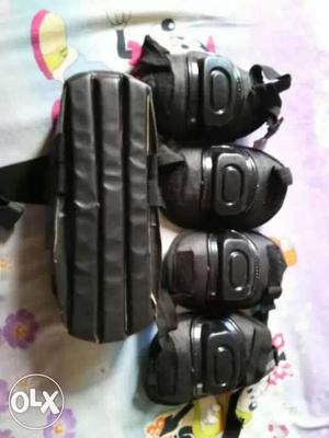 Pairs Of Black Knee Pads and elbow pads and also helmet