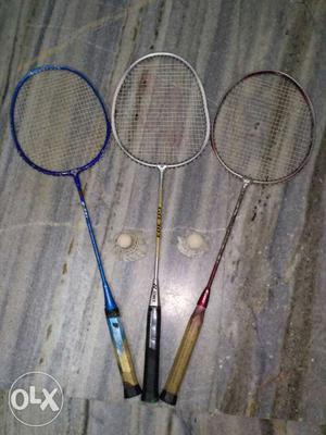 Three Blue, Brown And White Badminton Rackets
