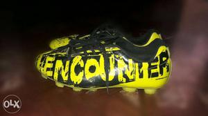 Unpaired Black And Yellow Cleats